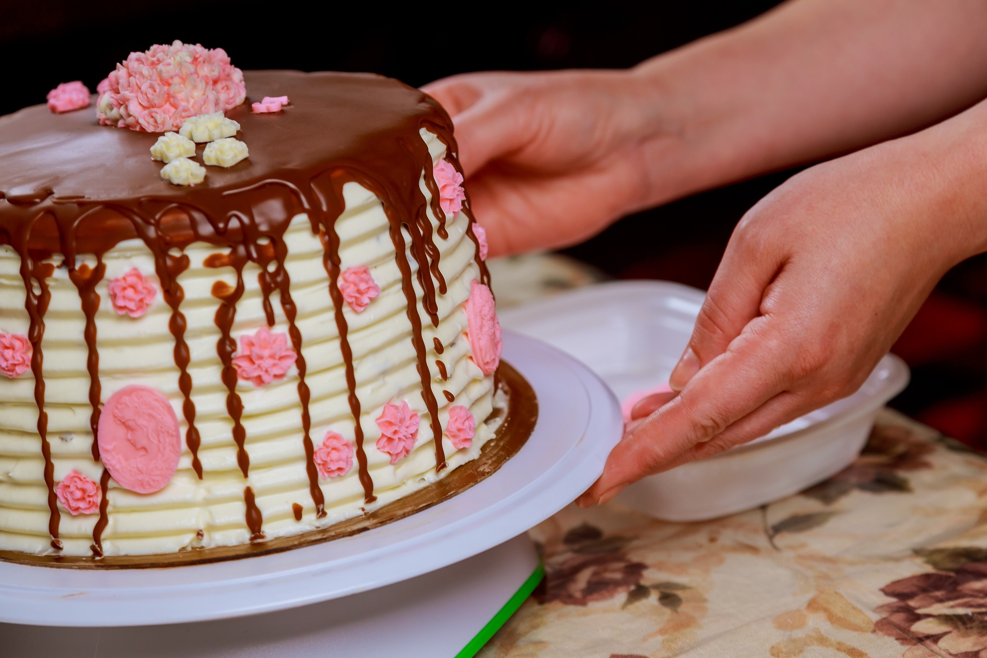 covering a cake with chocolate icing sponge cake covered in chocolate